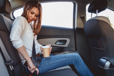 Lady putting on seat belt