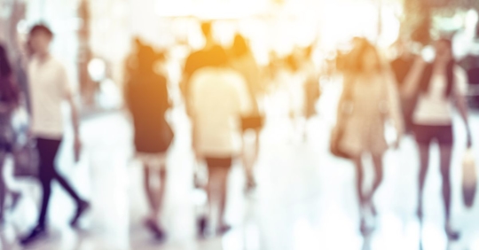 out of focus image of people walking on a sidewalk