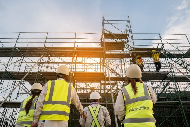 Safety Officers at Construction Site with Scaffolding