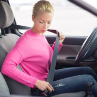 Lady putting on seat belt