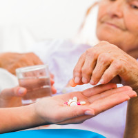 Woman prescribing medicine to elder woman