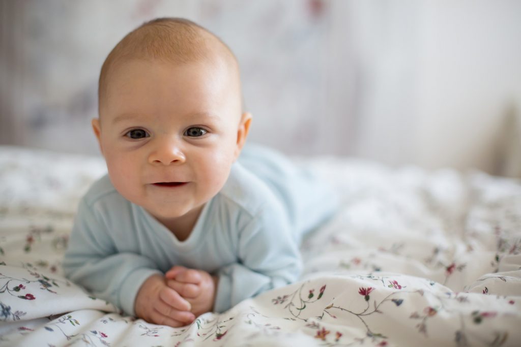 Baby smiling while laying on stomach