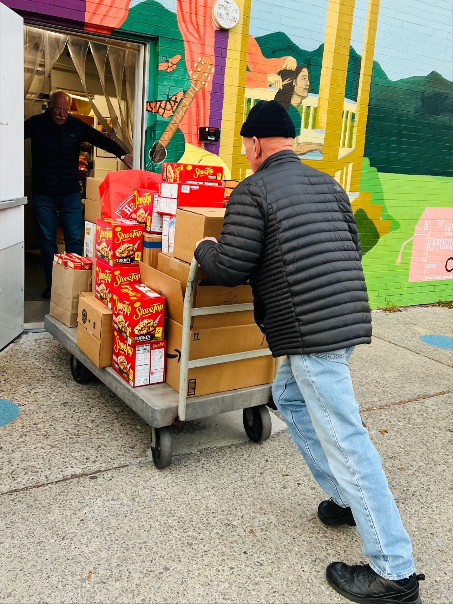 Man pusing a cart of boxes Photo