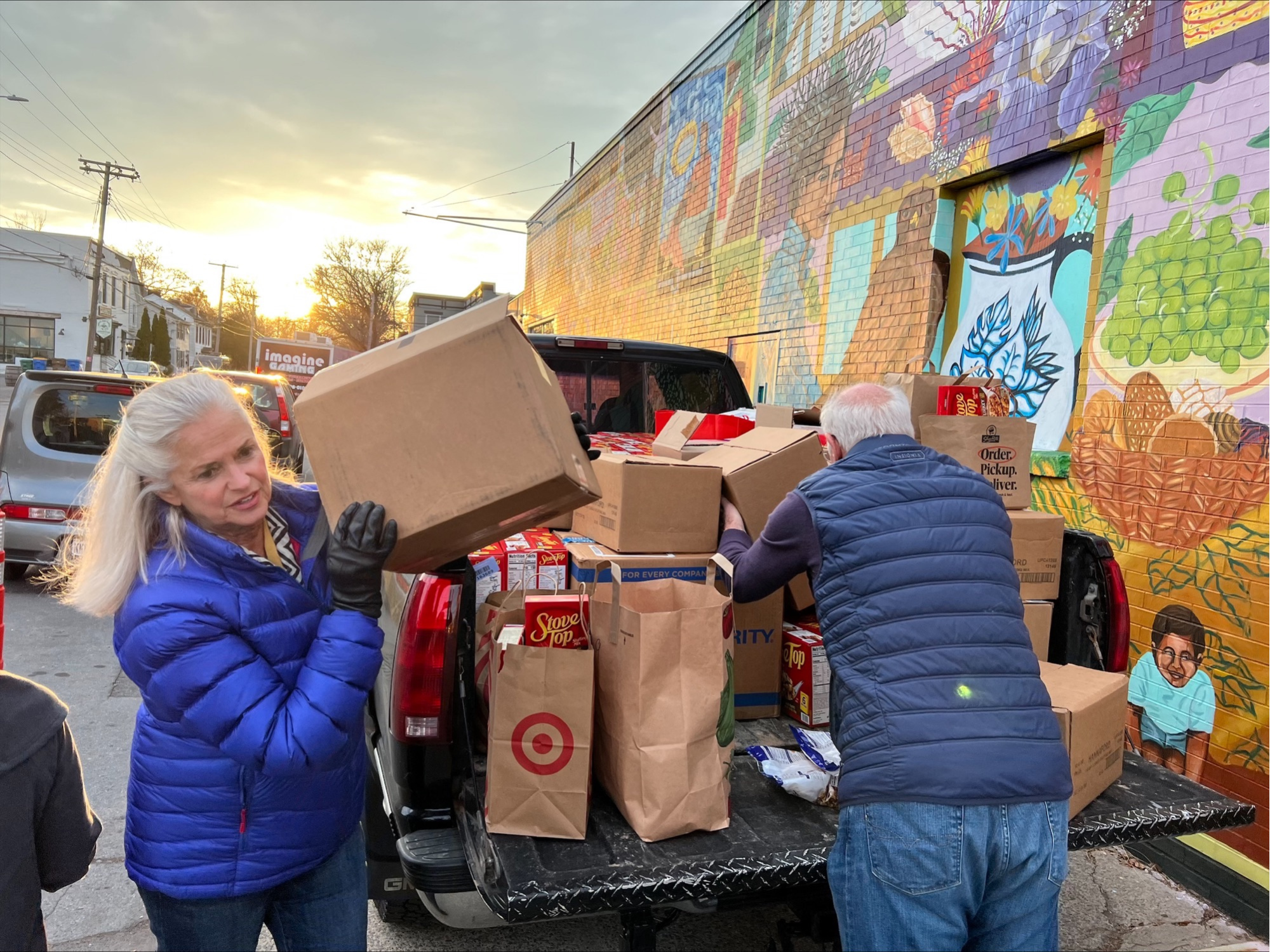 Woman and man carrying grocery Photo